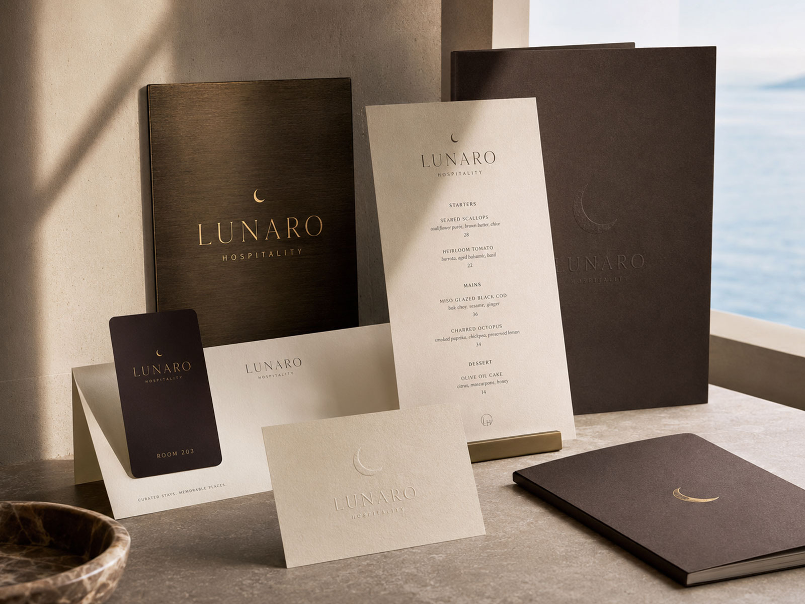 Lunaro Hospitality brand identity presented across premium hotel and restaurant collateral